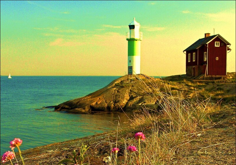 Lighthouse on Rocky Shore — Green, Serene, Afternoon, Photograph