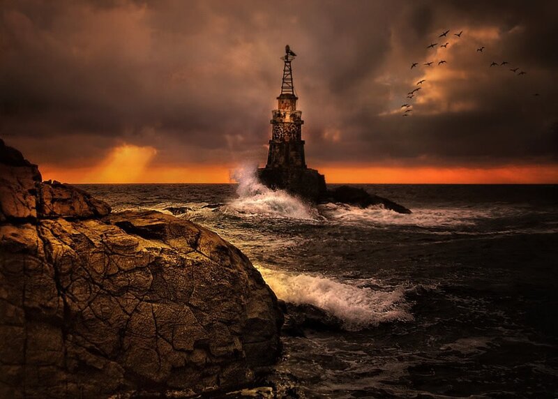 Lighthouse on Rocky Shore — Orange, Dramatic, Sunset, Photograph