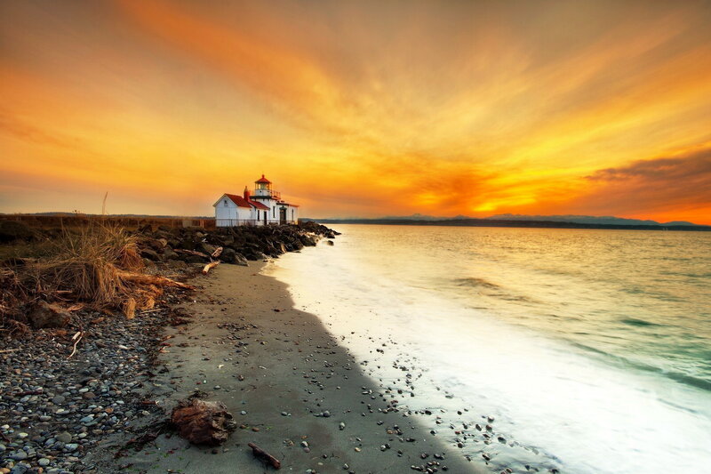 Lighthouse on Rocky Shore — Orange, Serene, Sunset, Photograph