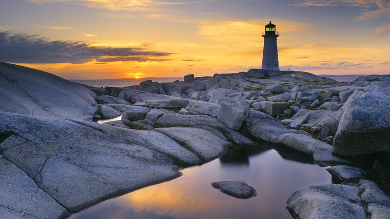 Lighthouse on Rocky Shore — Orange, Serene