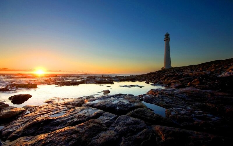 Lighthouse on Rocky Shore — Photograph