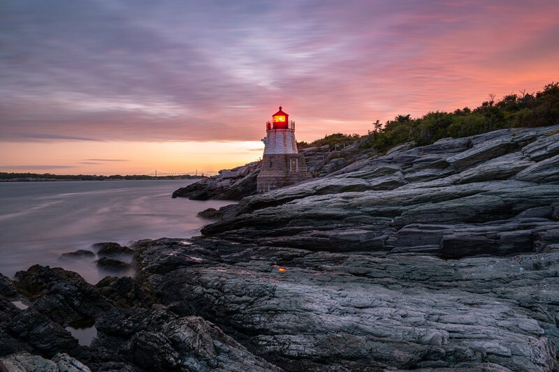 Lighthouse on Rocky Shore — Pink, Serene, Sunset
