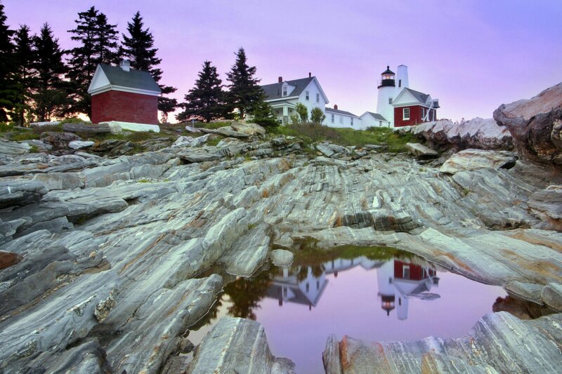 Lighthouse on Rocky Shore — Purple, Serene, Sunset, Photograph, Rocks, Trees