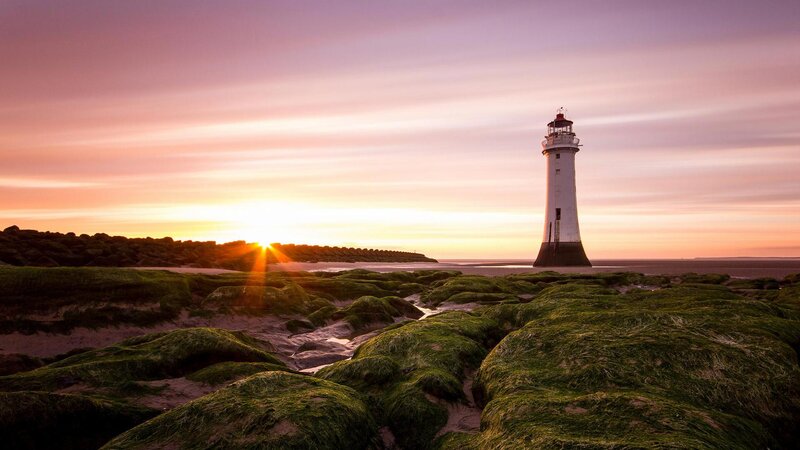 Lighthouse on Rocky Shore — Purple, Serene, Sunset, Photograph, Sun