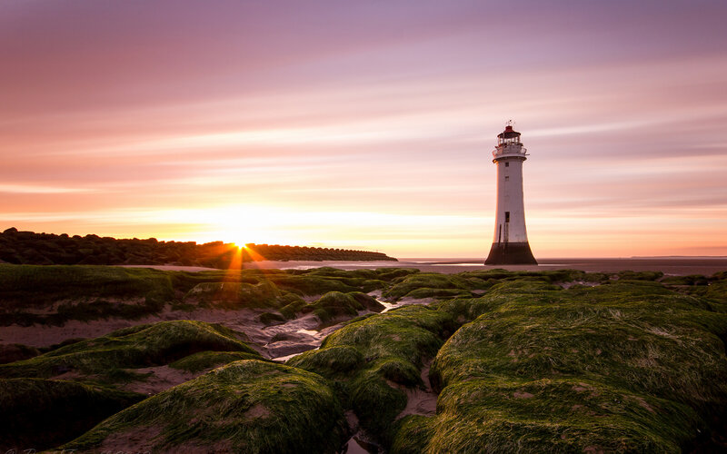 Lighthouse on Rocky Shore — Purple, Serene, Sunset, Photograph, Sunrise