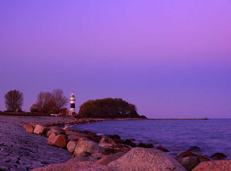 Lighthouse on Rocky Shore — Purple, Serene, Sunset