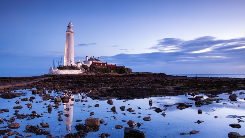 Lighthouse on Rocky Shore — Sunset