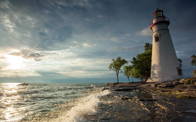 Lighthouse on Rocky Shore — White, Dramatic, Sunset, Photograph, Boat