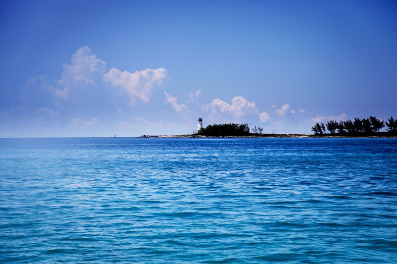 Lighthouse on Small Island — Blue, Serene, Afternoon