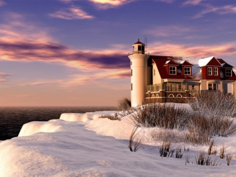 Lighthouse on snowy coast at sunset