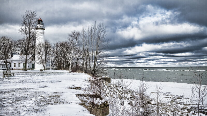 Lighthouse on Snowy Shore — White, Dramatic