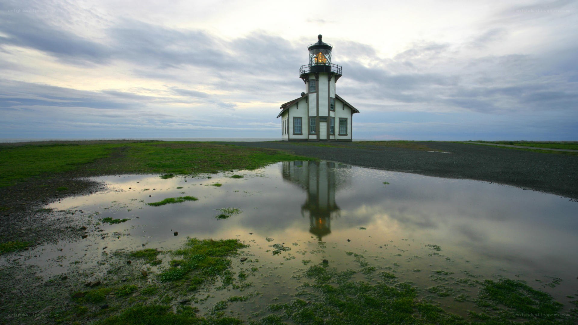Lighthouse reflected in a puddle