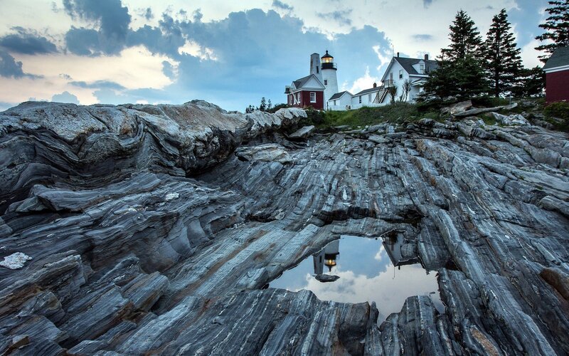 Lighthouse reflected in a rock pool