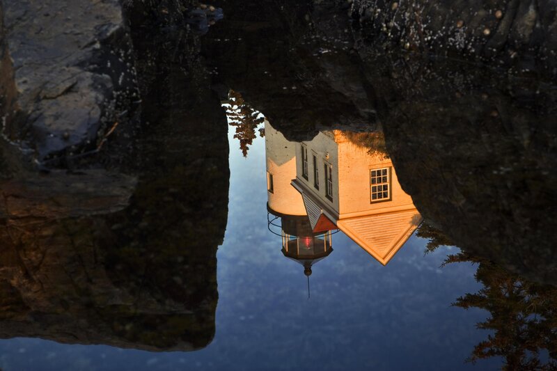 lighthouse reflected in water