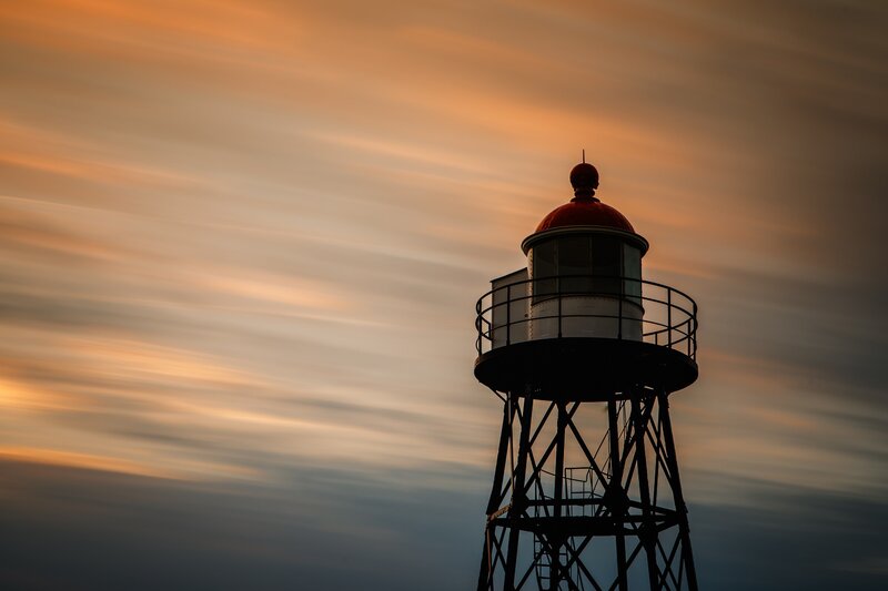 Lighthouse Silhouette — Orange, Dramatic