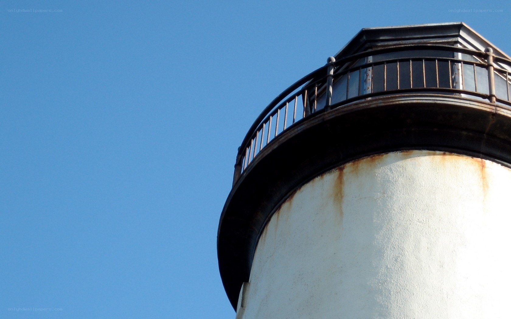 lighthouse top against blue sky