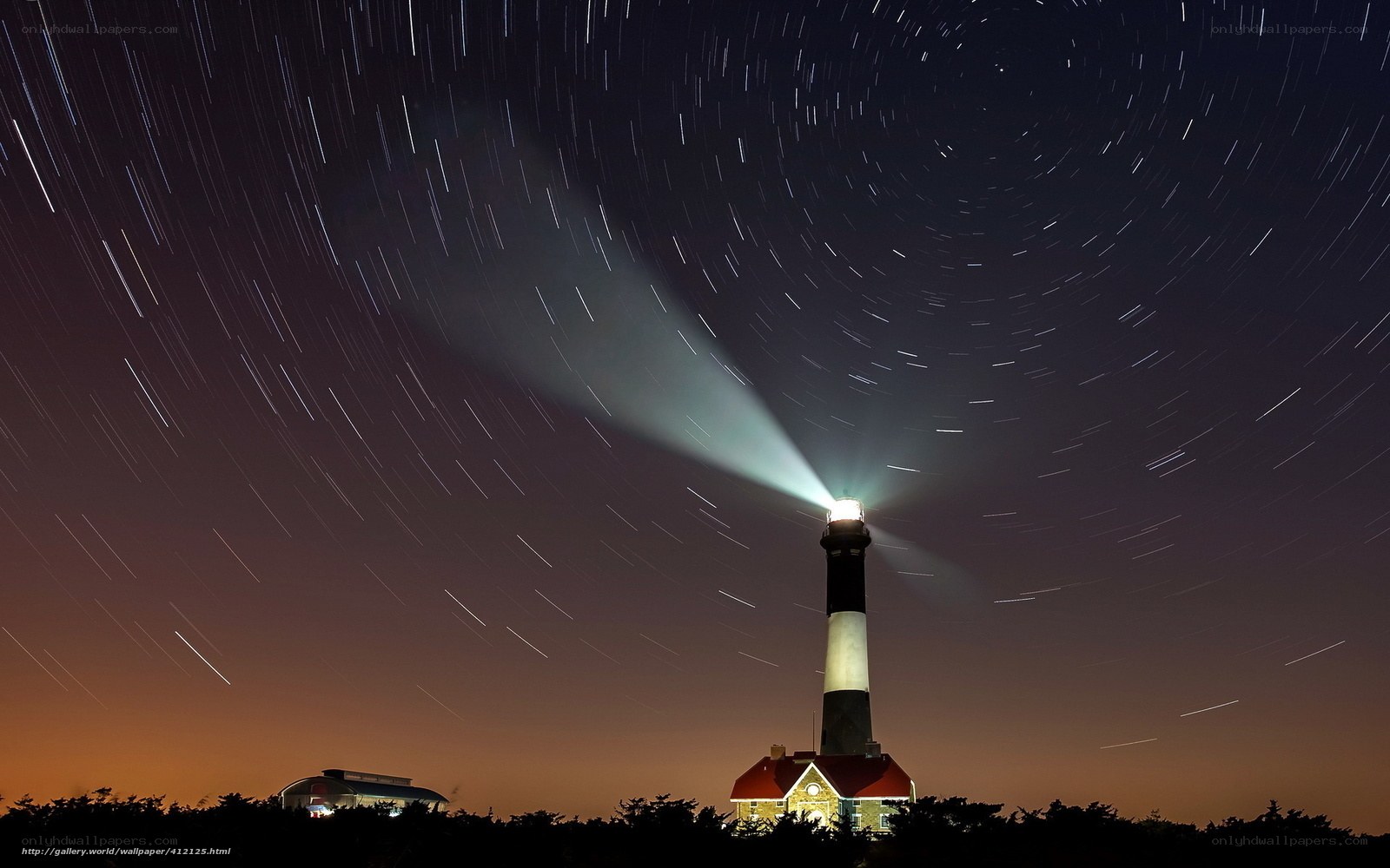 Lighthouse under star trails