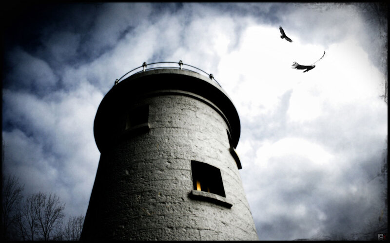 lighthouse under stormy sky