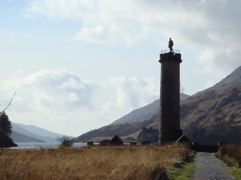 Lighthouse with statue on hillside