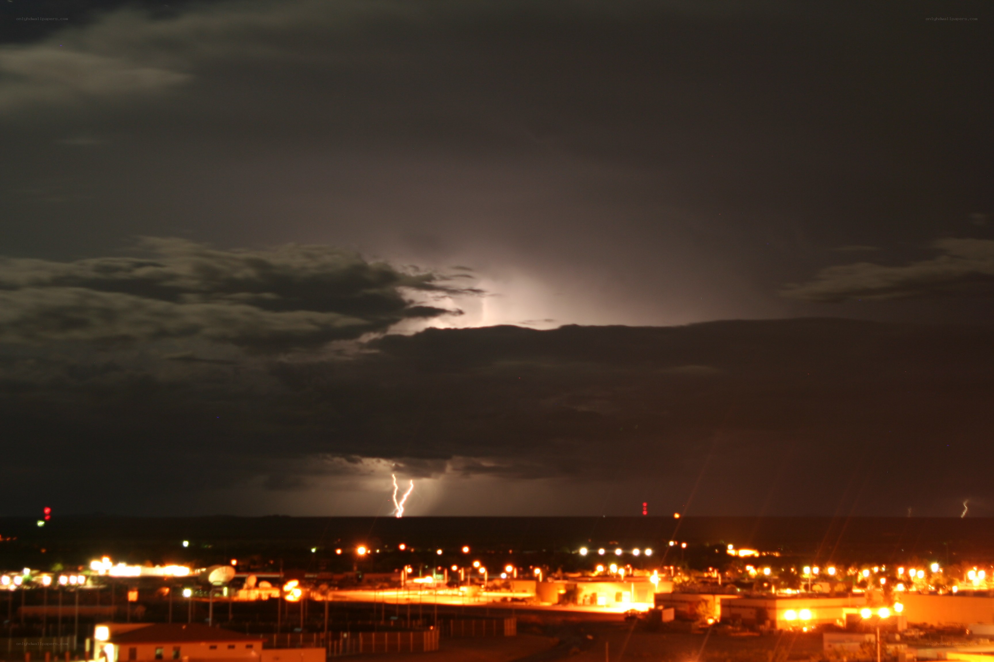 Lightning over a city at night