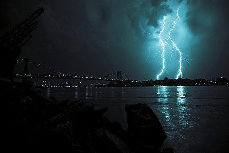 Lightning over a city bridge