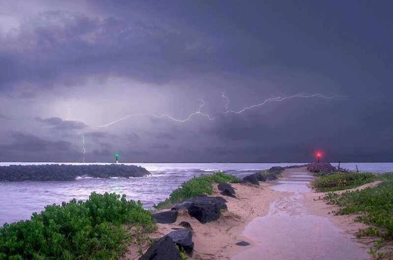 Lightning over a coastal jetty
