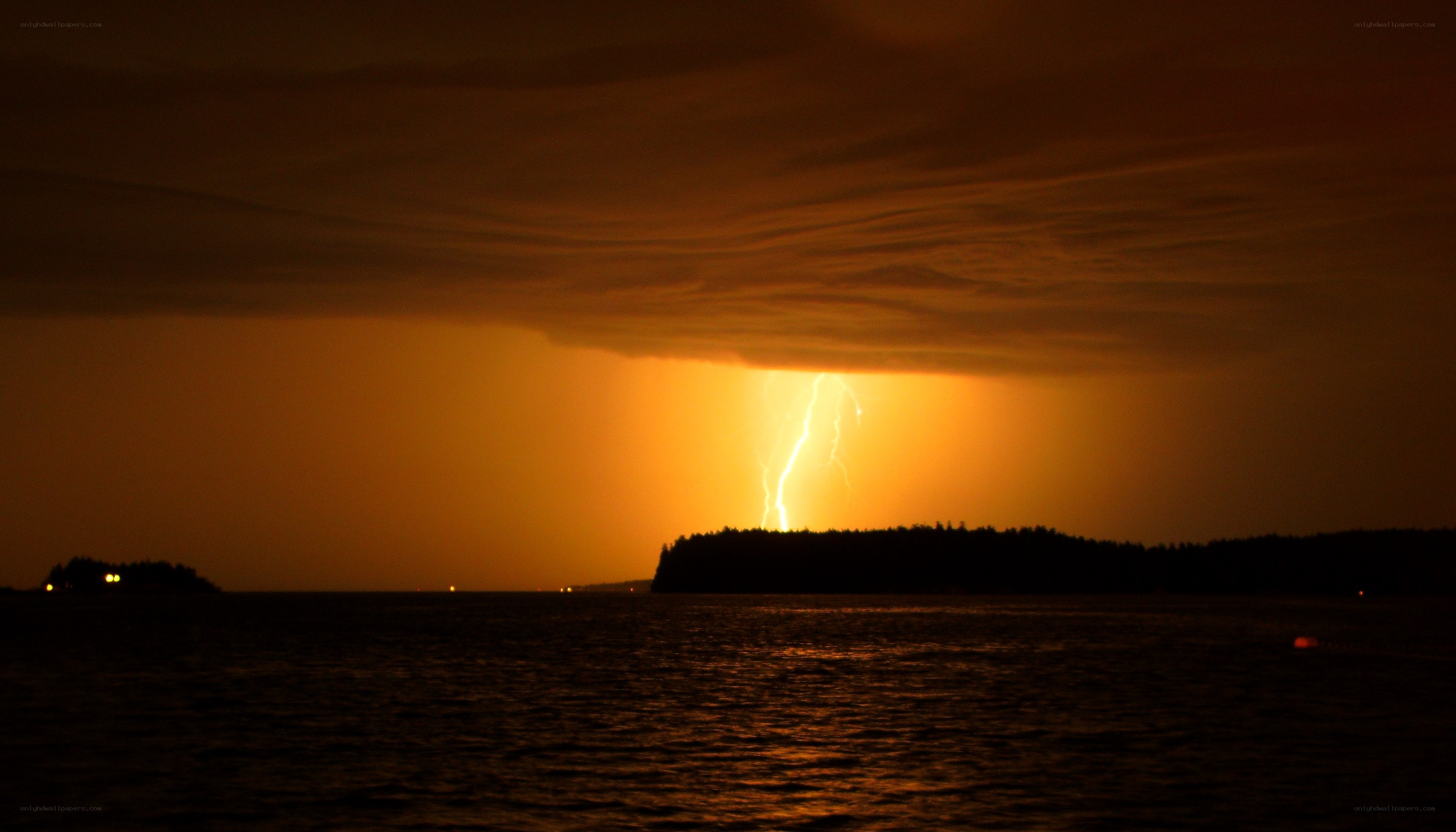 Lightning over a coastal landscape