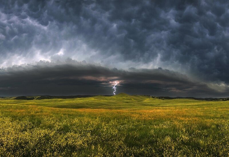 Lightning over a green field