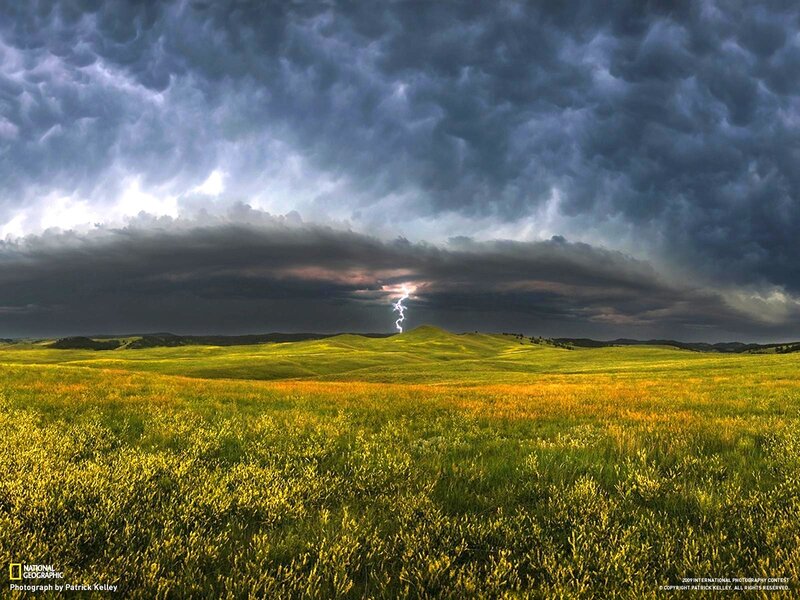 Lightning over a green field