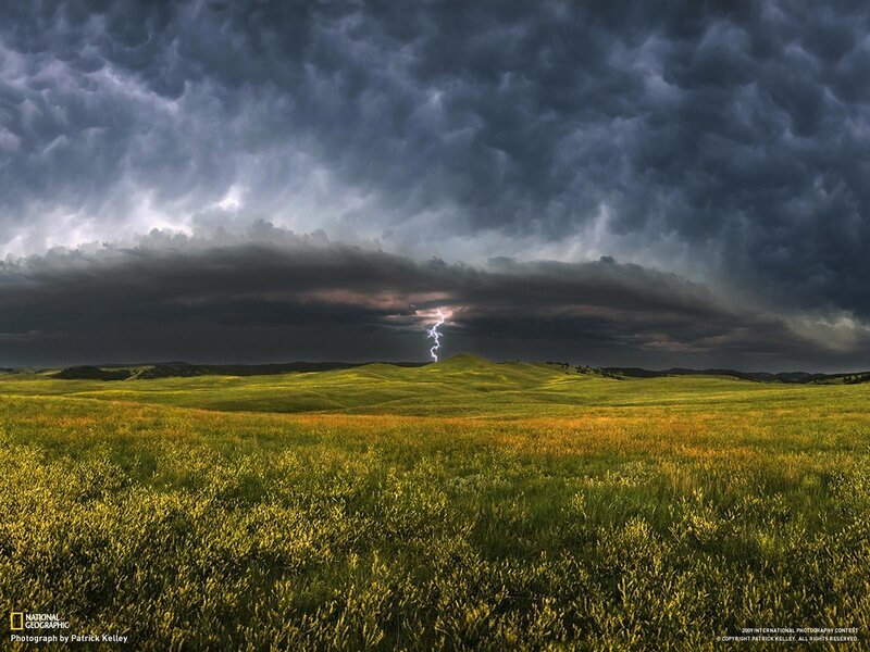 Lightning over a green field