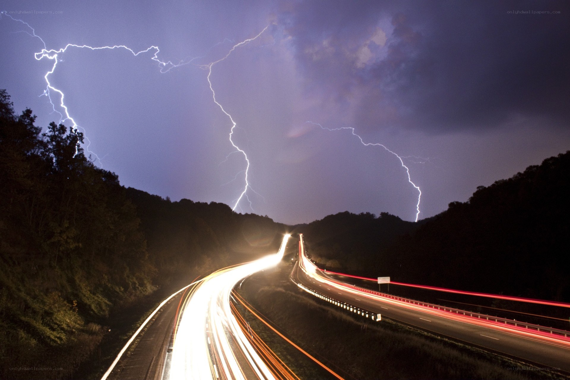 Lightning over a highway at night