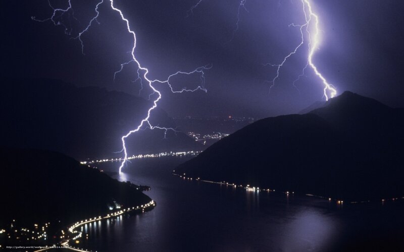 Lightning over a lake at night