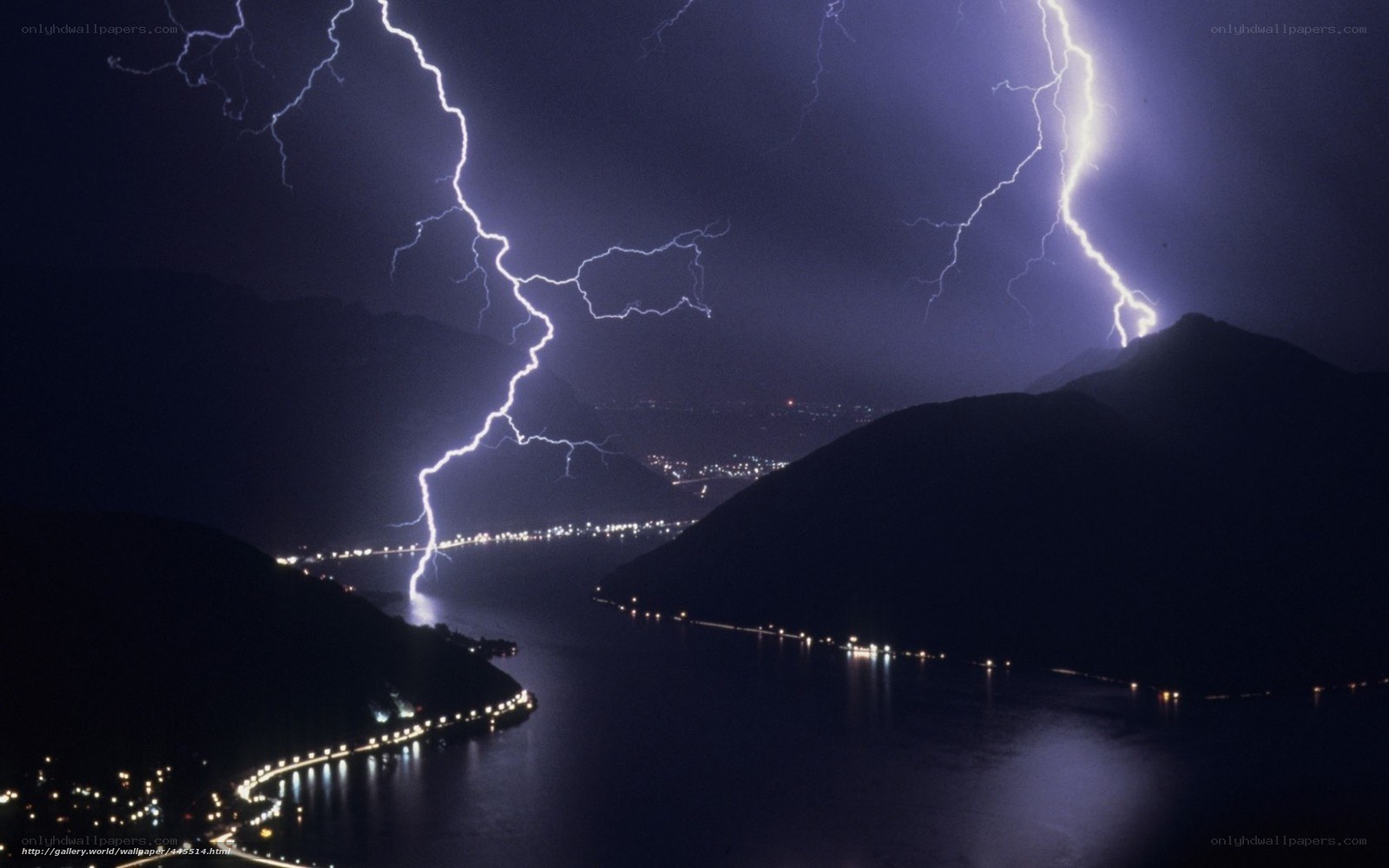 Lightning over a lake at night