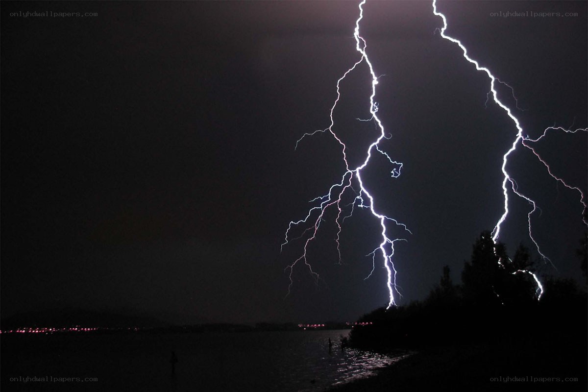 Lightning over a lake at night