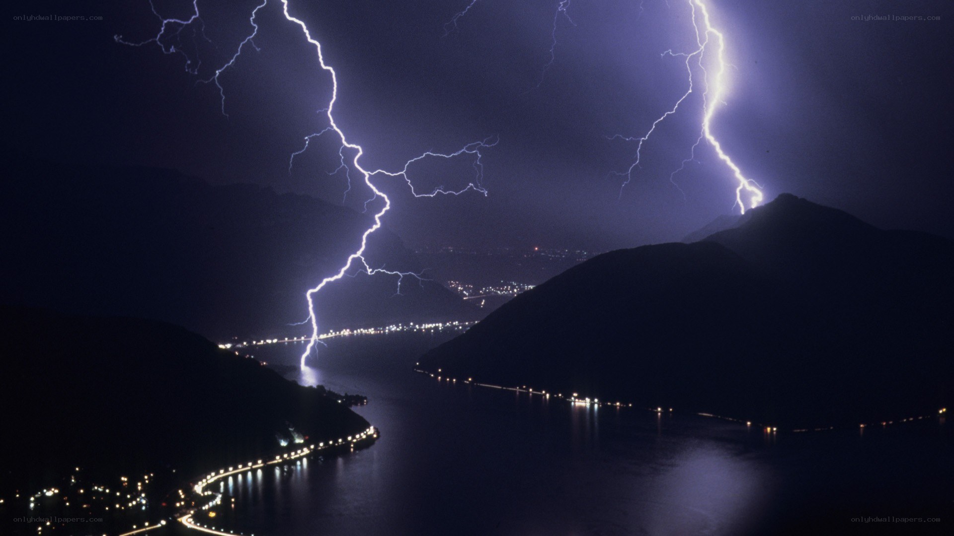 Lightning over a lake at night