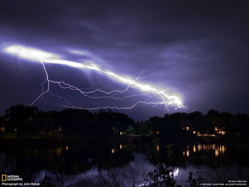 Lightning over a lake at night