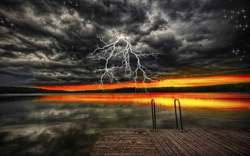Lightning over a lake at sunset