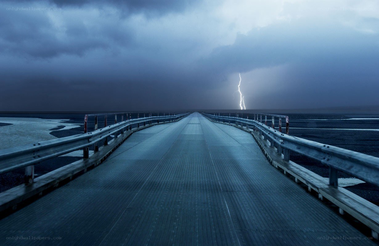Lightning over a long bridge