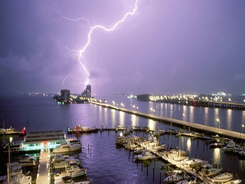 Lightning over a marina at night