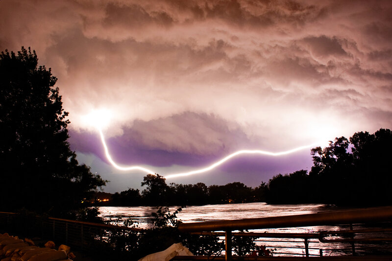 Lightning over a river at night