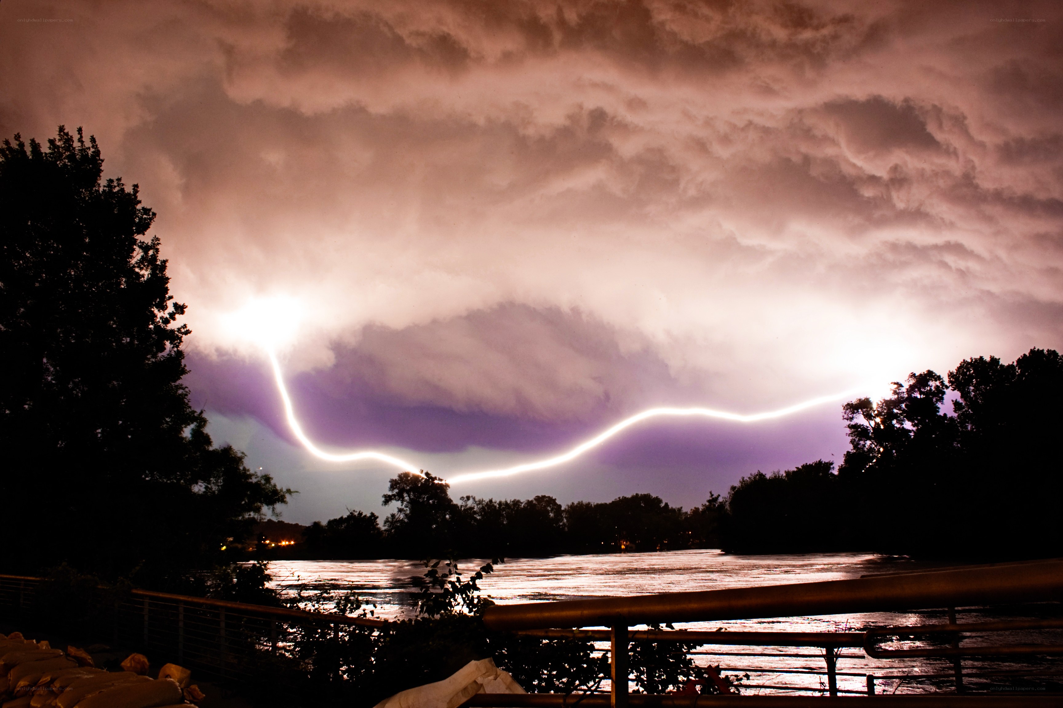 Lightning over a river at night