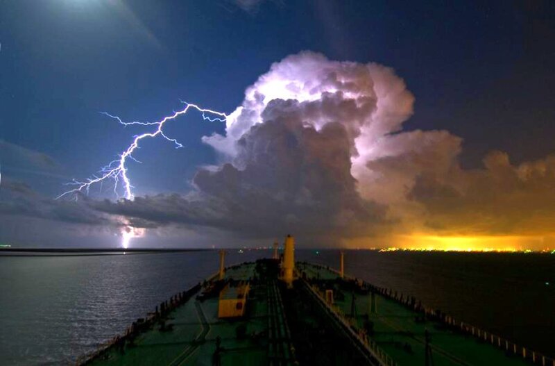Lightning over a ship at night