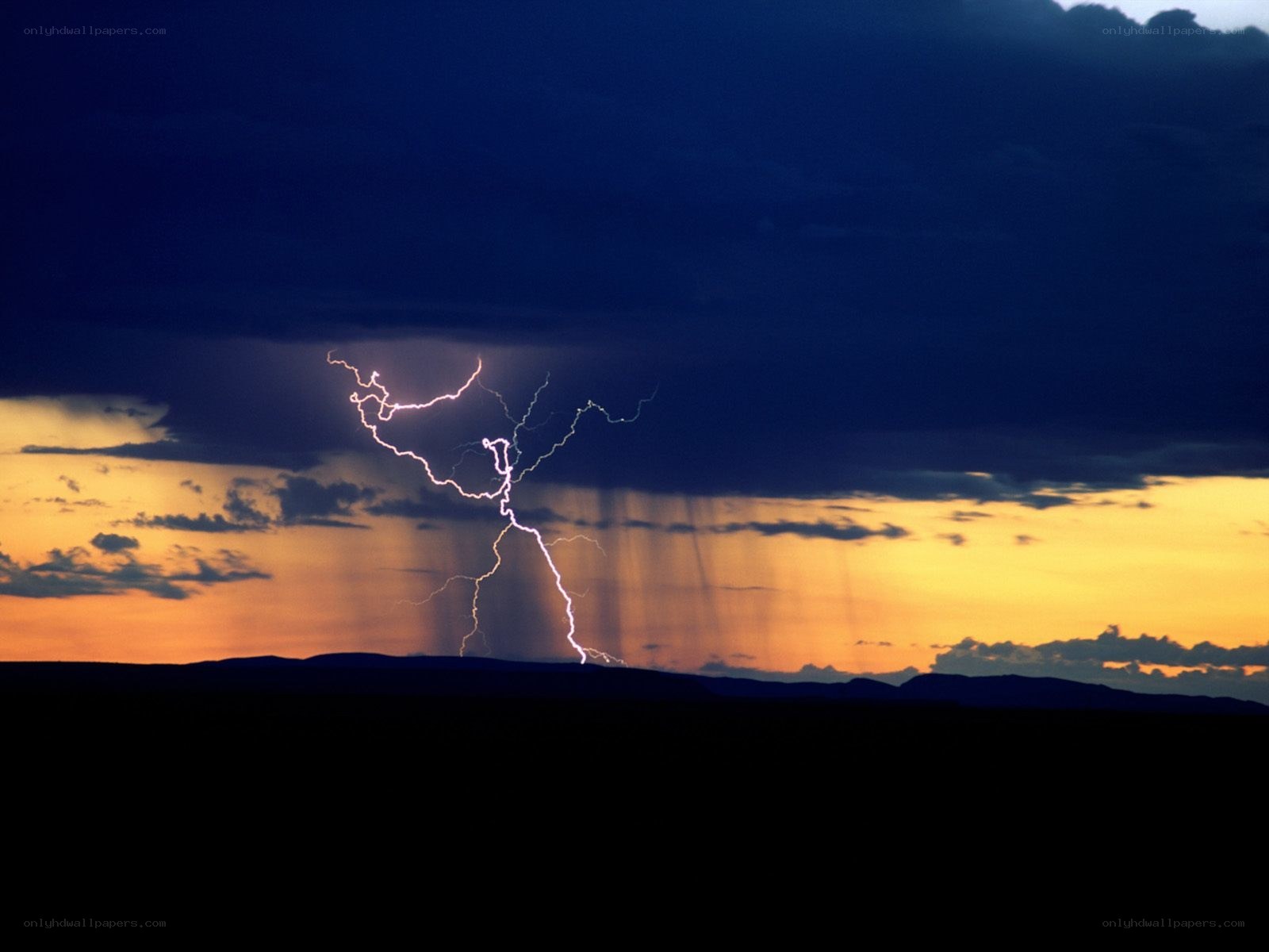 Lightning over a sunset landscape