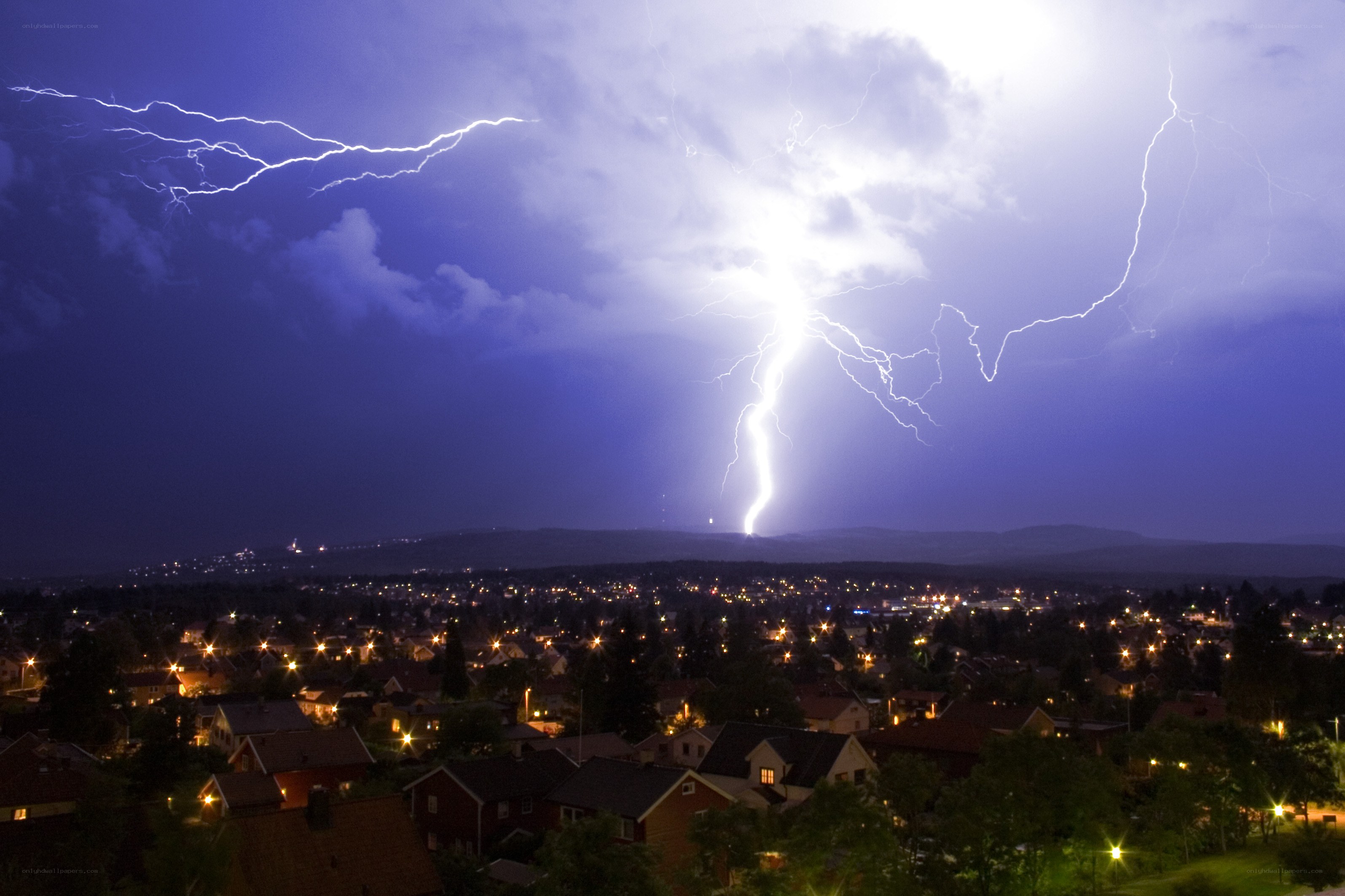 Lightning over a town at night