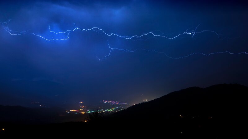 Lightning over a valley at night