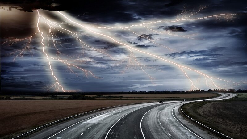 Lightning over a winding road