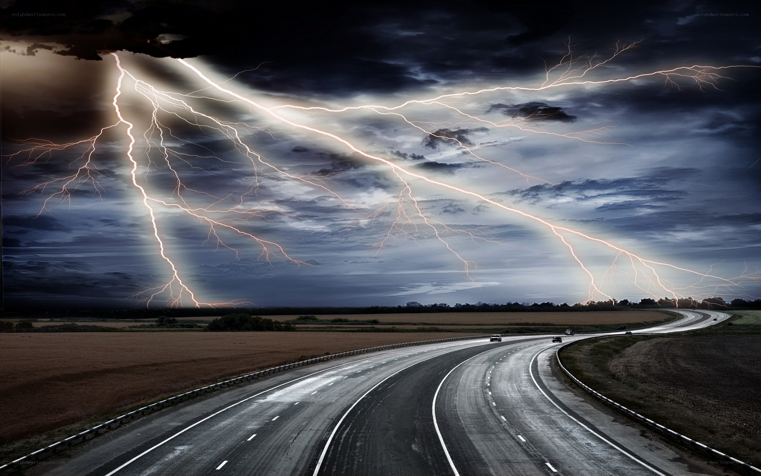 Lightning over a winding road