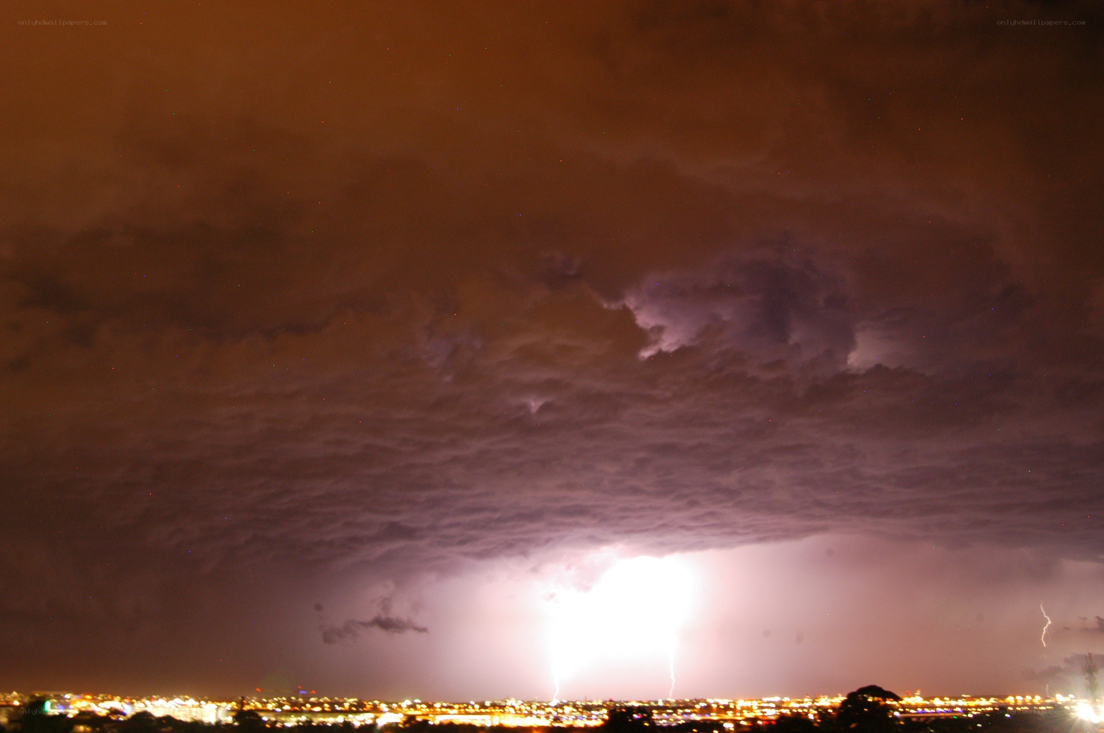 Lightning over city at night