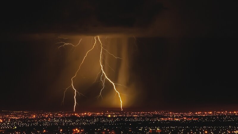 Lightning over city at night