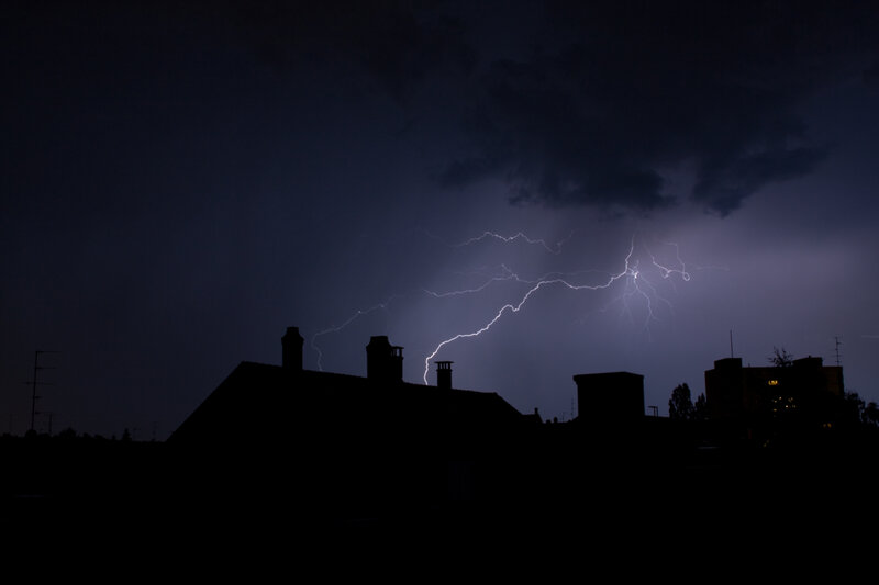 Lightning over city rooftops